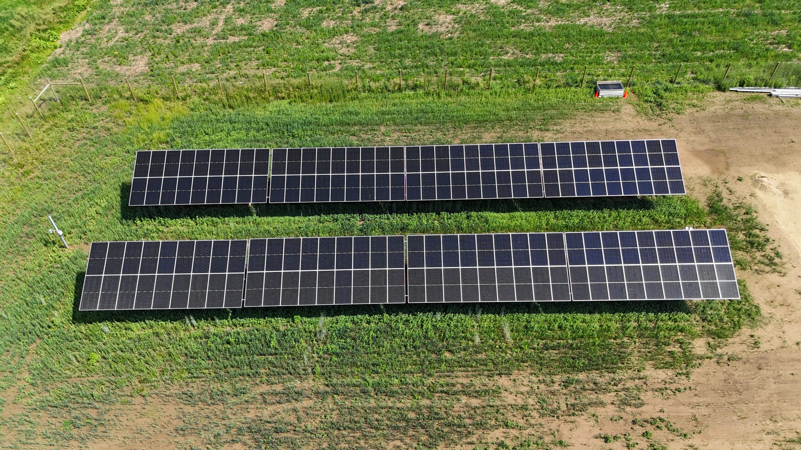 Elevated solar array structure with wide interrow spacing and vegetation